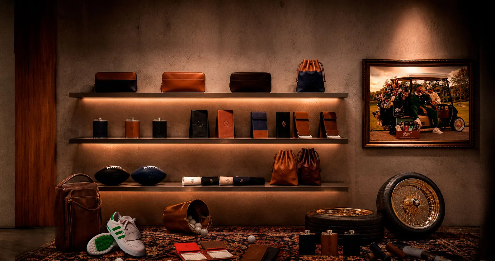 RICAL leather flasks, wallets, pouches and headcovers displayed on a lit shelf